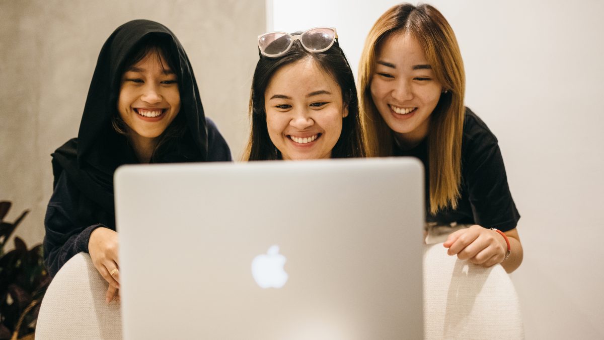 group-of-workers-looking-at-laptop