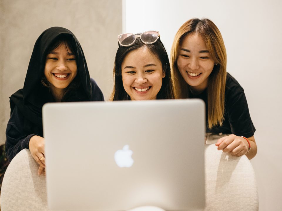 group-of-workers-looking-at-laptop